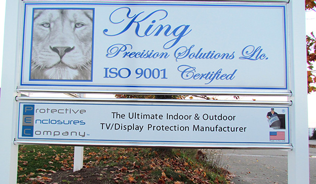 A board displaying King Precisions and partner company Protective Enclosures Company